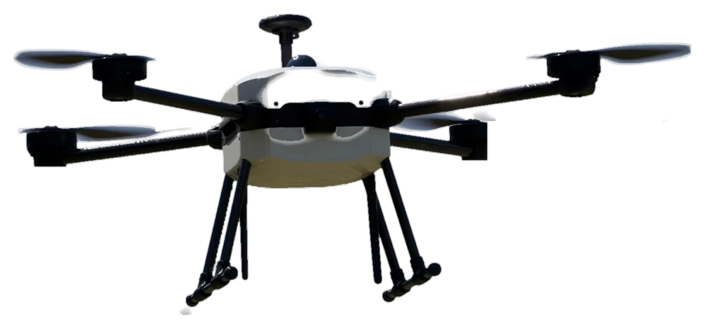 RoboCore v letu: bílé tělo, čtyři ramena s vrtulemi, přistávací nohy